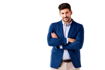 Confident businessman standing with arms crossed at isolated white background