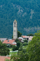 Fototapeta premium Malles Venosta alpine town of Trentino Alto Adige and south Tyrol. Bell tower and landscape views.