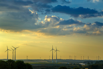 wind turbines and modern solar panels in the rural landscape