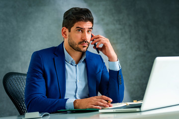 Unhappy businessman having a call while working from home