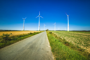 Fototapeta na wymiar power generating wind turbines in the countryside