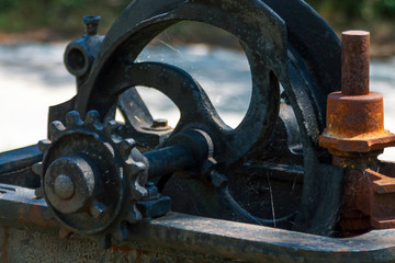An old excavated mechanism, part of an unshaven assembly, covered with cobwebs
