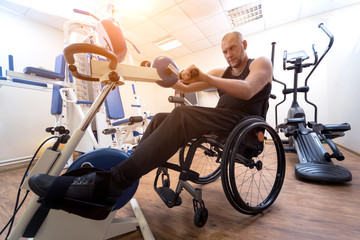 Fototapeta na wymiar Disabled man training in the gym. Rehabilitation center