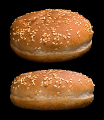 Two burger buns isolated on black background