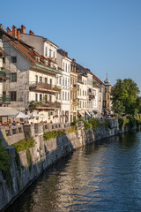 Fototapeta na wymiar Old houses at the riverside of river Ljubljanica in Ljubljana