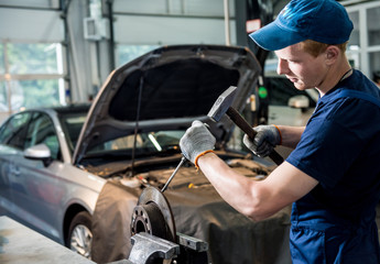 Car mechanic repair car brakes at service station. Car repair service