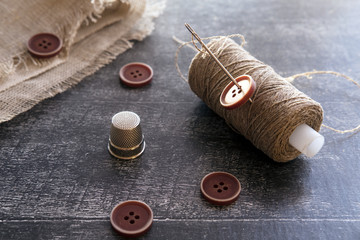 Sewing kit. Linen thread, needle, buttons, background, buttons, close-up, closeup, fabric, linen thread, needle, needlework, sew, sewing kit, tool, white, wood