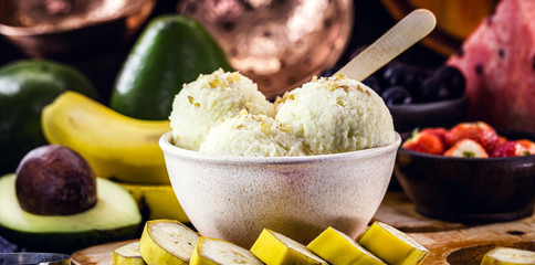vegan banana ice cream, vegan dessert without added sugar and without milk, with fruits around....