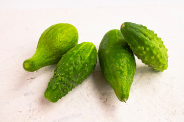 Ugly cucumbers on a white background
