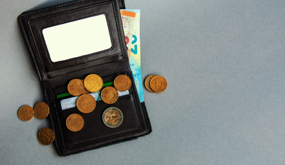 old wallet with euro banknotes and coins