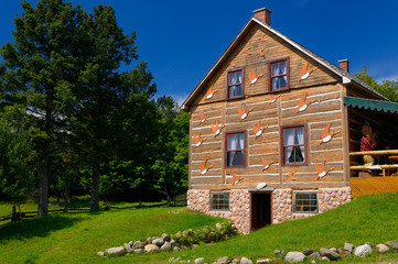 Historic French Canadian log farmhouse with Canada Geese decoration at Park Omega Quebec