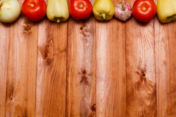 Autumn cooking background with seasonal organic vegetables on wooden table, top view, copy space. Ingredients for autum seasonal soups and dishes.