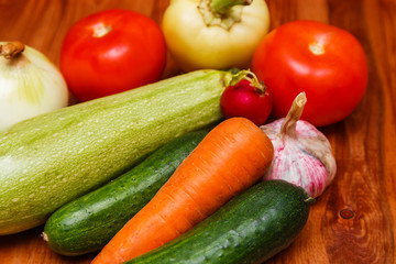 Autumn cooking background with seasonal organic vegetables on wooden table, top view, copy space. Ingredients for autum seasonal soups and dishes.