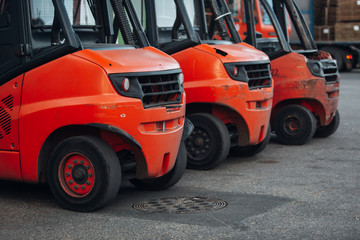 Pallet stacker truck at the port. Parking of equipment of huge industrial park ready for container...