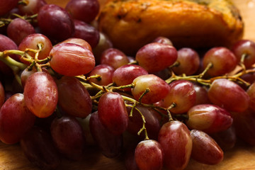 Grapes and garlic bread lie on the table