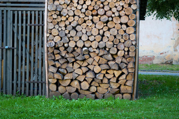 The firewood is stored under a canopy.