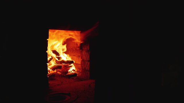 An Italian rustic wood-burning stove ignites. Big flame. Preparing for the preparation of a traditional Italian meal. Pizza and lasagna