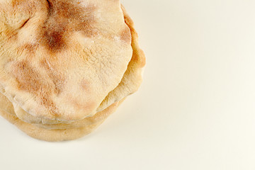 pita or arabic breads on white surface with writing space