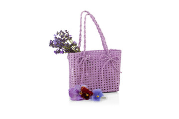 Fototapeta na wymiar wicker bag with lavender flowers isolated on white
