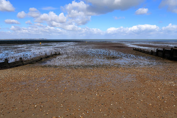 A view of the pebbled beach at Whitstable with the tide out