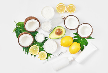 Natural organic homemade cosmetics with lemon, avocado and coconut. Skin care. Spa salon and treatments. Beautician background. Clay, lemon, beauty products.Tropical summer concept. Flat lay