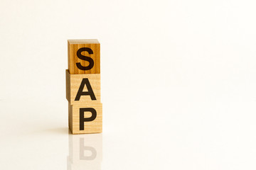 Concept image of business acronym SAP as Systems Applications Products written over wooden blocks