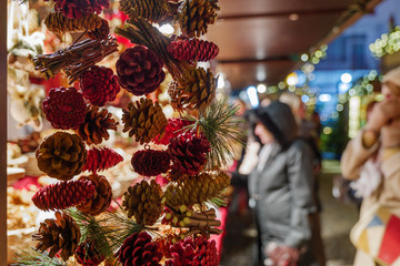 Naklejka premium Selective focus at hanging dry natural Mini Pine Nuts Cedar for decoration, in front of stall at Weihnachtsmarkt, Christmas Market. 