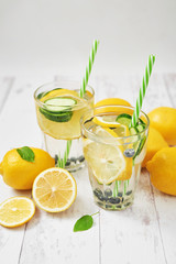 Detox water with sliced lemon, cucumber and blueberries. Diet healthy eating and weight loss. Ice cold summer cocktail or lemonade in glass mason jar. Health care, fitness, healthy nutrition