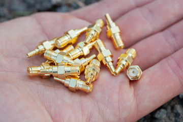 High-frequency SMA connectors isolated on black background.