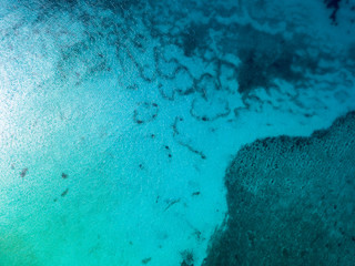 Fototapeta na wymiar Aerial drone view of transparent water of Caribbean Sea and coral reef floor at the bottom near Saona Island, Dominican Republic 