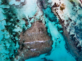 Aerial drone view of transparent water of Caribbean Sea and coral reef floor at the bottom near Saona Island, Dominican Republic 