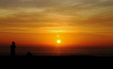 Naklejka na ściany i meble Sunset on the green coast of Lima.