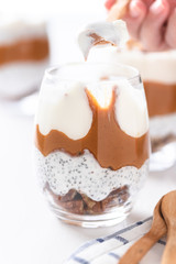 Yogurt with chia, peanut cream and nuts jars.