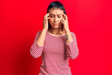 Young woman wearing casual clothes with hand on head for pain in head because stress. suffering migraine.