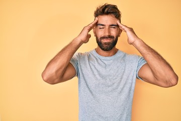 Young hispanic man wearing casual clothes suffering from headache desperate and stressed because pain and migraine. hands on head.