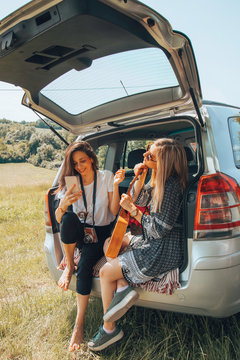 Two female friends travel around the world in a car. Vacation concept.