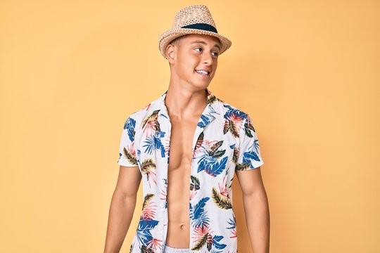 Young hispanic boy wearing summer hat looking to side, relax profile pose with natural face and confident smile.