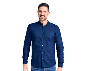 Fototapeta premium Young handsome man wearing casual shirt winking looking at the camera with sexy expression, cheerful and happy face.