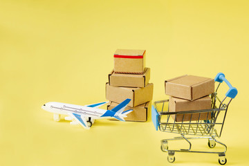 Airplane and stack of cardboard boxes. concept of air cargo and parcels, airmail. Fast delivery of...
