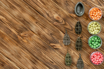 Accessories for carp fishing and fishing baits on wooden planks with copy space
