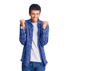 Young african amercian man wearing casual clothes excited for success with arms raised and eyes closed celebrating victory smiling. winner concept.