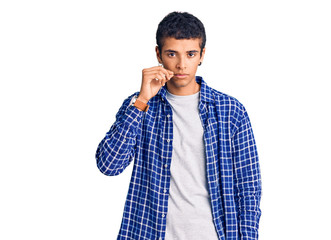 Young african amercian man wearing casual clothes mouth and lips shut as zip with fingers. secret...