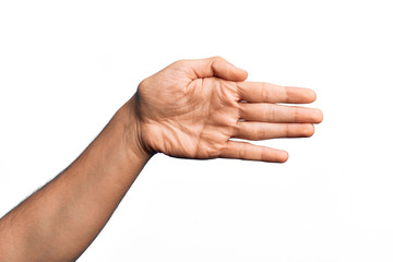 Hand of caucasian young man showing fingers over isolated white background stretching and reaching with open hand for handshake, showing palm