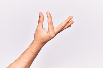 Close up of hand of young caucasian man over isolated background picking and taking invisible thing, holding object with fingers showing space