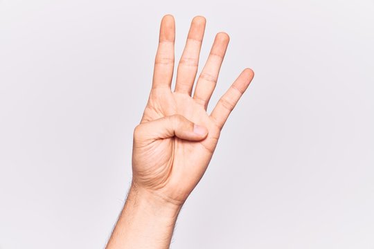 Close up of hand of young caucasian man over isolated background counting number 4 showing four fingers