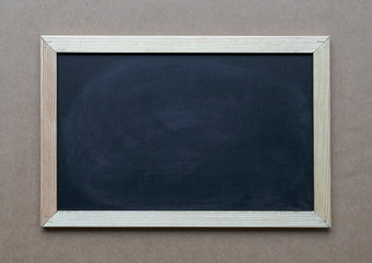 Blank blackboard on brown carrdboard background