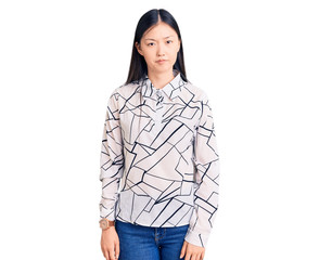 Young beautiful chinese woman wearing casual shirt skeptic and nervous, frowning upset because of problem. negative person.
