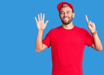 Naklejka premium Young handsome blond man wearing t-shirt and cap showing and pointing up with fingers number six while smiling confident and happy.