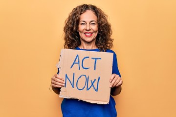 Fototapeta na wymiar Middle age beautiful woman asking for react holding banner with act now message looking positive and happy standing and smiling with a confident smile showing teeth