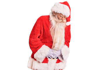 Old senior man with grey hair and long beard wearing traditional santa claus costume with hand on stomach because indigestion, painful illness feeling unwell. ache concept.